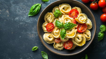 A delightful serving of fresh tortellini topped with juicy tomatoes and fragrant basil, perfect for a vibrant meal in any culinary setting.の素材