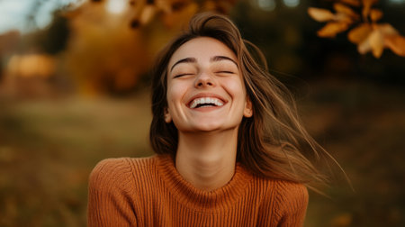 A joyful woman smiles brightly in an autumn landscape, surrounded by golden leaves and natural beauty, capturing a moment of pure happiness and warmth.の素材