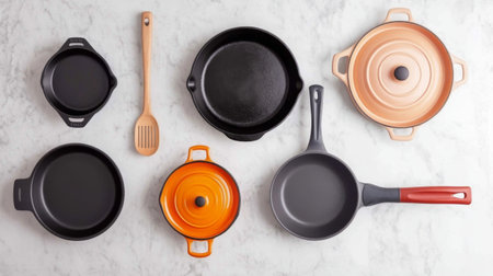 A stylish arrangement of various cookware pieces on a marble surface. Features a mix of cast iron and ceramic pots and pans, ideal for kitchen enthusiasts.の素材