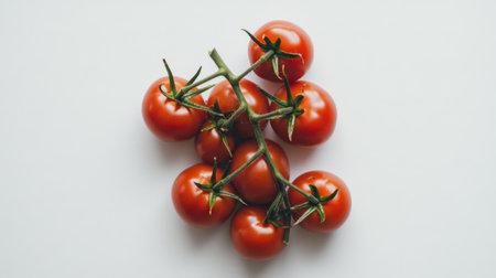A cluster of fresh cherry tomatoes on a branch captures the essence of healthy eating. Ideal for culinary, organic, and nutrition-themed projects.の素材
