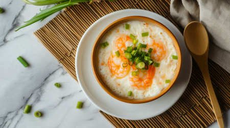 A vibrant bowl of cooked shrimp garnished with fresh green onions, served on a stylish plate, perfect for showcasing culinary creativity and fresh ingredients.の素材