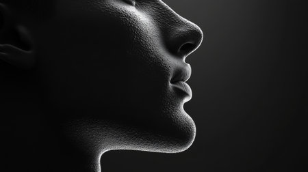 A striking monochrome profile of a face highlighting texture and elegance. The interplay of light and shadow creates a captivating visual experience.の素材