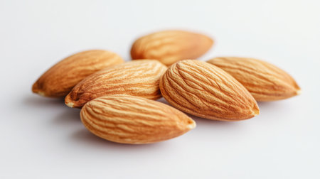 A close-up view of natural almonds showcasing their distinct texture and color. Perfect for healthy snack options or culinary uses in various recipes.の素材