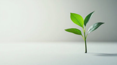 A vibrant green plant emerges from a smooth surface, symbolizing growth and new beginnings. Ideal for themes of nature, vitality, and sustainability.の素材
