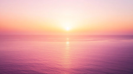 A breathtaking view of a serene sunset over calm ocean waters, showcasing soft hues of pink and orange. This tranquil landscape evokes a sense of peace and relaxation.の素材