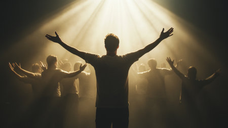 A striking image featuring a group of performers under a dramatic spotlight, with a central figure embracing the moment, creating a powerful and emotive scene full of energy and inspiration.の素材