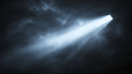 A captivating scene showcasing a striking light beam cutting through dark clouds, creating a mystical ambiance. This powerful image evokes a sense of wonder and tranquility.の素材