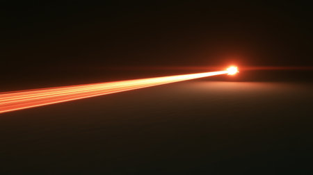 A vibrant red laser beam cuts through the dark space, creating an impactful visual effect. The dynamics of light showcase energy and technology in motion.の素材
