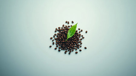 A captivating image of coffee beans surrounded by a vibrant green leaf, showcasing the natural beauty of fresh ingredients on a minimalist background.の素材