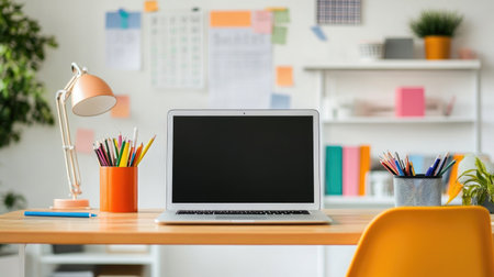 An organized study desk with a laptop, colorful stationery, and motivational quotes on the wall, creating an inspiring space for students and professionals alike.の素材
