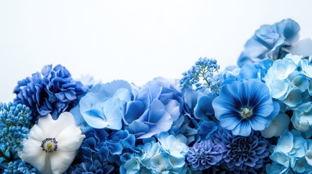 A blue-themed floral arrangement with different shades of blue flowers, creating a harmonious and elegant display with a clean, white background.の素材