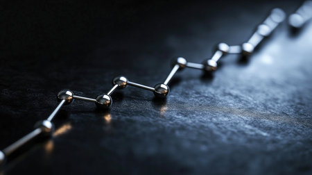 A smooth line graph in metallic silver, with ascending and descending lines on a black background, representing data progressの素材