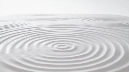 Concentric circles in various shades, layered to form a ripple-like pattern on a smooth white surface, symbolizing movement and energyの素材