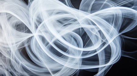 Close-up of white smoke rings swirling and overlapping in an intricate pattern on a black backgroundの素材