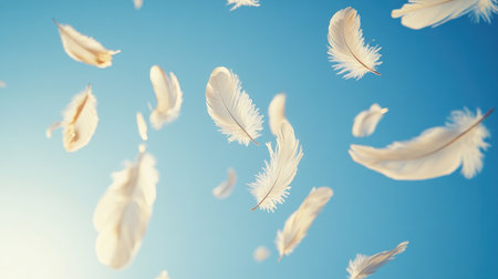 A soft breeze blowing through a cluster of feathers, causing them to float lightly in the air against a clear blue sky, symbolizing freedom and lightnessの素材