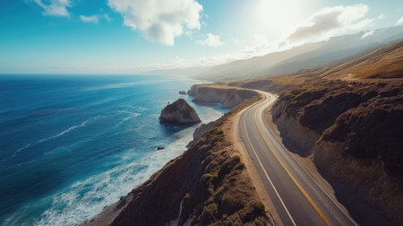 Wide shot of a coastal road with stunning ocean views and dramatic cliffs, under a bright, sunny skyの素材