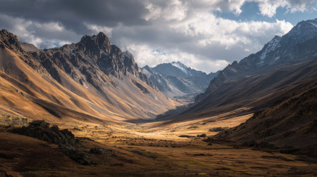 Discover a breathtaking mountain valley landscape filled with golden grasslands, dramatic clouds, and majestic peaks, embodying the tranquility of nature's beauty.の素材