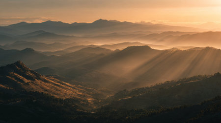 Experience the serene beauty of a majestic mountain range at golden hour, where soft light and mist create a stunning, tranquil landscape perfect for nature lovers.の素材