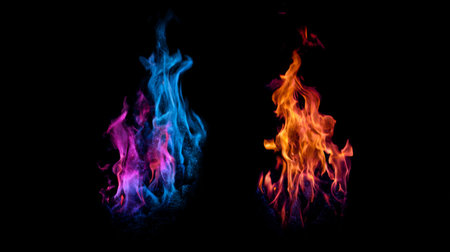 This captivating image features bright blue and orange flames dancing on a dark background, creating a striking contrast and a mesmerizing visual effect.の素材