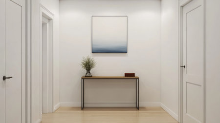Bright and minimalist hallway featuring a modern art piece. A simple wooden table adorned with a plant creates an inviting atmosphere in this clean space.の素材