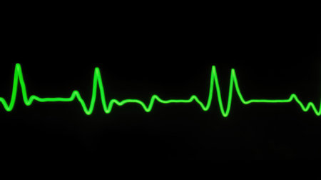 A vibrant green heartbeat line displayed against a black background, representing vital signs in medical contexts. Ideal for healthcare and tech themes.の素材