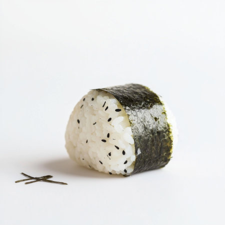 A visually appealing sushi ball made from rice and wrapped in nori with a sprinkle of black sesame seeds, reflecting the art of Japanese culinary traditions.の素材