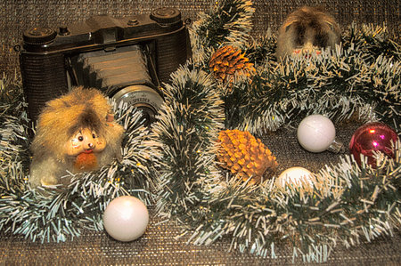 Green garland with white ends, Christmas tree balls: red, three white, two small toy mice, two pine conesの写真素材