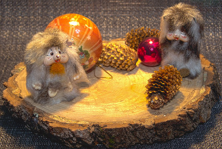 Two toy mice, a wooden path, Christmas balls â yellow and red, three pine conesの写真素材