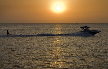 Water skiing on a beautiful summers eveningの写真素材