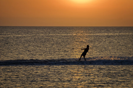 Man water skiing on a beautiful summers eveningの写真素材