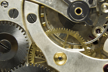 An extreme close up shot of the workings of a jeweled pocket watch