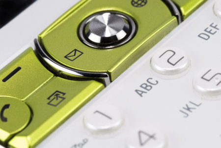 Macro shot of a mobile phone, focus on the message icon.