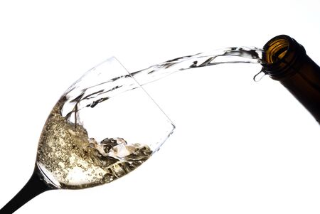 Wine pouring into a glass isolated on whiteの写真素材