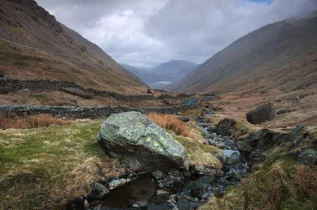 Stream flowing between the beautiful lake district mountains in Cumbria Englandの写真素材