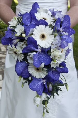 Bride holding a beautiful bouquet of flowers on her wedding dayの写真素材