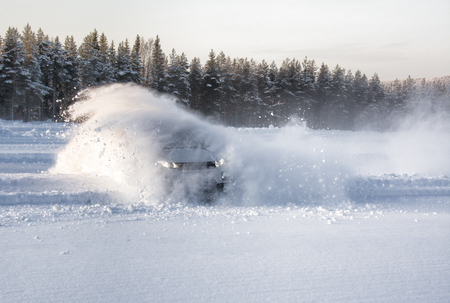 A vechical sliding into deep snow causing an explosion effectの写真素材