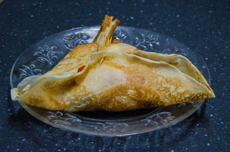 Two stuffed pancakes on a white plateの写真素材