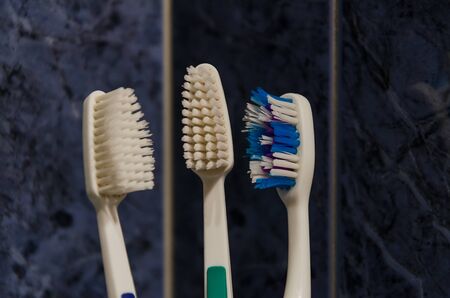 Toothbrush in a glass on a tile backgroundの写真素材