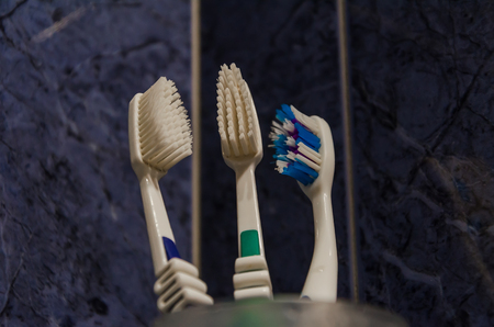 Toothbrush in a glass on a tile backgroundの写真素材