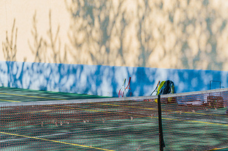 Tennis court with a grid for professional games. Bag for rackets.の写真素材
