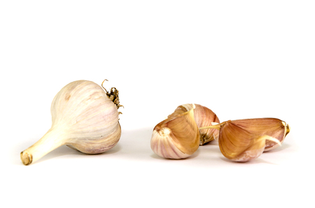 Slices of garlic closeup isolated on white background.の写真素材