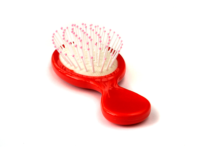 Elegant red hair comb brush with handle, isolated on transparent or white background. Front view.の写真素材