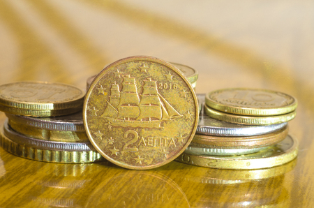 Coins closeup on a polished wooden table.の写真素材