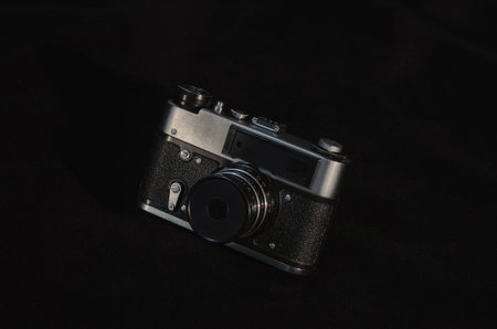 Old camera FED in different positions on a black background.