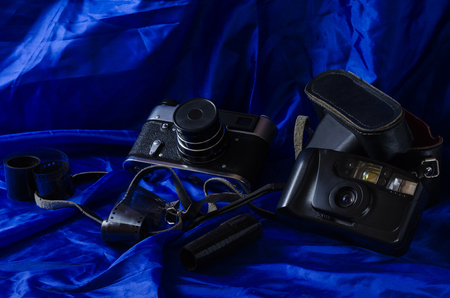 Still life photographic film and film camera on different backgrounds.の写真素材