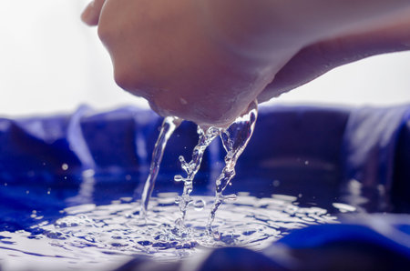 Children's hands in water and with water.