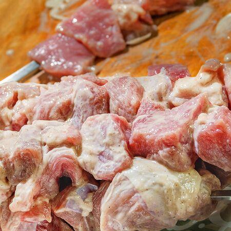 Beautiful pickled meat for barbecue on skewers.の写真素材