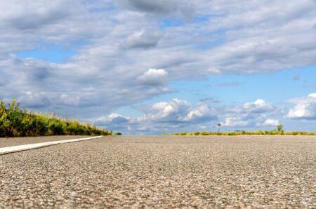 Asphalt road leading to the clouds.の写真素材