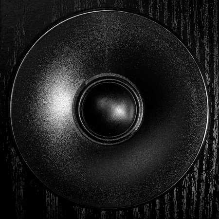High-resolution macro shots showing the intricate details of modern speaker components. The textures and design elements are highlighted in dramatic black and white tones, emphasizing precision engineering and audio aesthetics.の写真素材