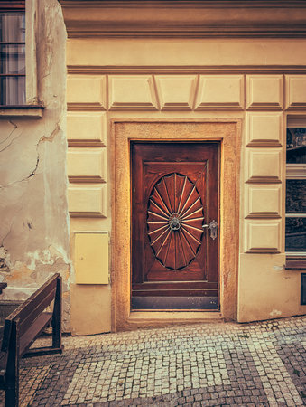 Old European wooden door with stone frame, showing classic architecture and cultural heritage.の写真素材